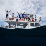 People jumping into the water from the private boat in Costa Rica