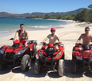 Three guys on ATV at beach tour