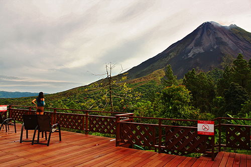 Woman watching the Arenal Volcano in Costa Rica