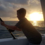 Child fishing at sunset in the private boat discovery combo
